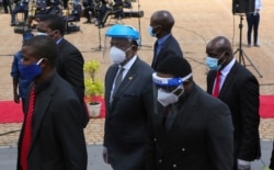 Zimbabwean Deputy President Constantino Chiwenga, center, arrives to officiate at the burial of three top government officials at the National Heroes Acre in Harare, Jan. 27, 2021.