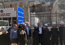 U.S. Ambassador to the U.N. Kelly Craft and James Jeffrey, the U.S. envoy for Syria, pose with rescue workers at the Syrian commercial crossing point of Bab al-Hawa opposite to Turkey's Cilvegozu border gate, in Idlib, Syria, March 3, 2020.