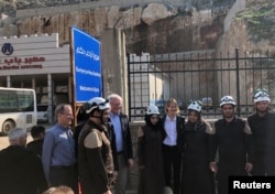 U.S. Ambassador to the U.N. Kelly Craft and James Jeffrey, the U.S. envoy for Syria, pose with rescue workers at the Syrian commercial crossing point of Bab al-Hawa opposite to Turkey's Cilvegozu border gate, in Idlib, Syria, March 3, 2020.