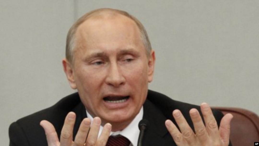 Russia's Prime Minister and President-elect Vladimir Putin answers a question of a deputy after addressing the parliament at the Russian State Duma in Moscow, April 11, 2012. 