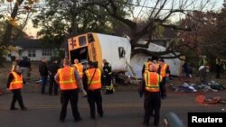 Rescue officials at the scene of a school bus crash involving several fatalities in Chattanooga, Tennessee, Nov. 21, 2016. Six children have died and the bus driving will face six vehicular homicide charges, police say. 