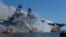 This U.S. Navy photo released July 13, 2020, shows sailors and federal firefighters battling a blaze onboard the amphibious assault ship USS Bonhomme Richard at Naval Base San Diego, California, July 12, 2020. (Christina Ross, U.S. Navy via AFP) 