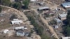 FILE - A view of damage in Asheville, N.C., is seen during an aerial tour with President Joe Biden who looked at areas impacted by Hurricane Helene near Asheville, N.C., Wednesday, Oct. 2, 2024.