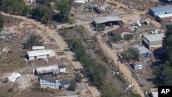 FILE - A view of damage in Asheville, N.C., is seen during an aerial tour with President Joe Biden who looked at areas impacted by Hurricane Helene near Asheville, N.C., Wednesday, Oct. 2, 2024.