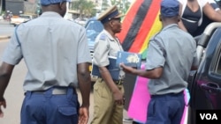 Police in Zimbabwe block protesters demanding the return of women stranded in Kuwait. (Photo: Mavis Gama)