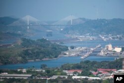 FILE - A cargo ship waits near the Centennial Bridge for transit through the Panama Canal locks in Panama City on January 17, 2024.