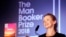 Writer Anna Burns smiles after she was presented with the Man Booker Prize for Fiction 2018 by Britain's Camilla, the Duchess of Cornwall, during the prize's 50th year at the Guildhall in London, Oct. 16, 2018. 