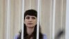 FILE - Journalist Katerina Borisevich sits inside a defendants' cage during a court hearing in Minsk, Belarus, March 2, 2021. (Sergei Sheleg/BelTA/Handout via Reuters)