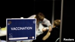 A senior citizen receives the Moderna coronavirus vaccine at a vaccination center in Le Cannet, France, Jan. 19, 2021. 