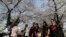 Visitors take their souvenir photos with cherry blossoms in Seoul, South Korea, April 7, 2017. 