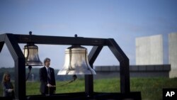 FILE - Bells are tolled for each of the 40 passengers that perished on Flight 93 during a memorial service at the Flight 93 National Memorial, which officially opened yesterday in Shanksville, Pennsylvanian Sept. 11, 2015.