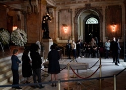 Relatives pay their last respects to Brazilian cultural icon João Gilberto during his wake at the Municipal Theater in Rio de Janeiro, Brazil, July 8, 2019.