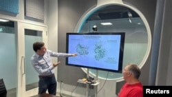 Robert Parrish, Head of the Quantum Chemistry division at QC Ware, and Matt Johnson, CEO of QC Ware, review computations on large metalloproteins in Palo Alto, California, U.S. on March 29, 2023. (QC Ware/Handout via REUTERS)