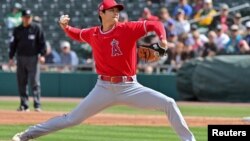 Los Angeles Angels starting pitcher Shohei Ohtani (17) throws in the first inning against the Oakland Athletics during a Spring Training game at Hohokam Stadium, Mesa, Arizona, Feb. 28, 2023. 