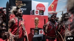 Kenya's Maasai tribe dancers perform upon the arrival of the special aircraft carrying the FIFA World Cup Trophy during its World Tour, Feb. 26, 2018 at the Jomo Kenyatta International airport in Nairobi. 