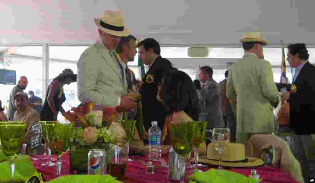 Mexico's Ambassador to the U.S. Arturo Sarukhan talks to racegoers at the International Pavillion. As host, the ambassador showcased his country's cuisine, tequila and produce at a tent by the finish line. (VOA - C. Babb)