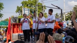 Pro-democracy movement protest leaders from left, Parit Chiwarak, Panupong Jadnok, Panusaya Sithijirawattanakul and Shinawat Chankrajang address supporters after answering charges at a police station in Northaburi, Thailand, Dec. 8, 2020.