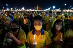 Supporters of the monarchy participate in a candle-lighting ceremony to mark the anniversary of the birth of late King Bhumibol Adulyadej at Sanam Luang ceremonial ground in Bangkok, Thailand, Dec. 5, 2020.