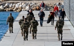 French soldiers patrol near the Museum of Civilizations from Europe and the Mediterranean (MuCEM) in Marseille, France, as security increases after last Friday's deadly attacks in Paris, Nov. 20, 2015.