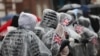 Members of the public watch the London's New Year's Day Parade event under rainy weather, in London, Britain, Jan. 1, 2025. 