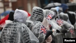 Members of the public watch the London's New Year's Day Parade event under rainy weather, in London, Britain, Jan. 1, 2025. 