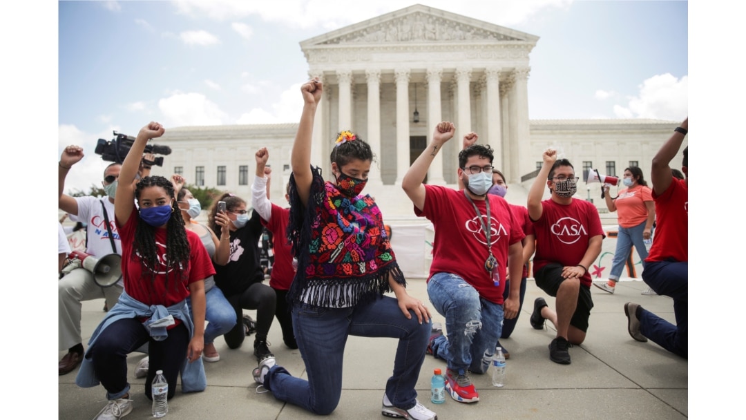 DACA recipients and their supporters take a knee in support of the Black Lives Matter movement, outside the U.S. Supreme Court in Washington, June 18, 2020.
