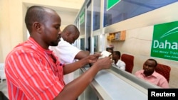 A Somali man collects his money at a Dahabshiil money transfer office in southern Mogadishu, May 8, 2013.