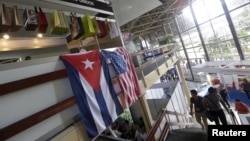 U.S. and Cuban flags hang on a wall at the U.S pavilion during the Havana International Fair (FIHAV), Havana, Cuba, Nov. 2, 2015. 