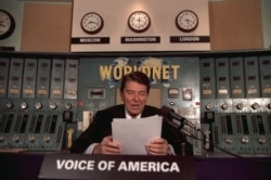 President Ronald Reagan gives his weekly radio address, Nov. 9, 1985, from a Voice of America studio in Washington.