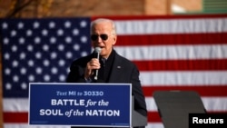 Democratic presidential nominee Joe Biden speaks at a campaign drive-in mobilization event in Flint, Mich., Oct. 31, 2020.
