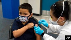 FILE - Eric Aviles, 6, gets a COVID-19 vaccine at a vaccine clinic for children ages 5-11 in Santa Ana, Calif., Nov. 9, 2021.