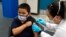 FILE - Eric Aviles, 6, gets a COVID-19 vaccine at a vaccine clinic for children ages 5-11 in Santa Ana, Calif., Nov. 9, 2021.