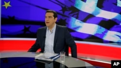 Greece's Prime Minister Alexis Tsipras prepares for a TV interview at the State Television (ERT) in Athens, June 29, 2015. 