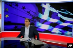 Greece's Prime Minister Alexis Tsipras prepares for a TV interview at the State Television (ERT) in Athens, June 29, 2015.