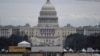 Workers break down parts of the spectators' tents at the U.S. Capitol in Washington on Jan. 18, 2025, after President-elect Donald Trump’s inauguration was moved indoors due to inclement weather.