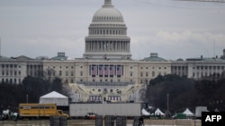 Workers break down parts of the spectators' tents at the U.S. Capitol in Washington on Jan. 18, 2025, after President-elect Donald Trump’s inauguration was moved indoors due to inclement weather.