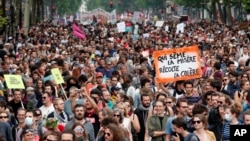 Thousands of protesters take part of an afternoon march against President Emmanuel Macron's pro-business reforms and to demand more social justice in Paris, May 26, 2018.