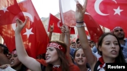 FILE - Demonstrators wave Turkish flags as they shout nationalist slogans during a protest against Kurdistan Workers' Party (PKK) in central Istanbul, Aug. 16, 2015. 