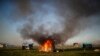 A shack home burns as people are evicted from a squatters camp by police in Guernica, Buenos Aires province, Argentina. Evicted families say they have nowhere to go amid the COVID-19 pandemic.