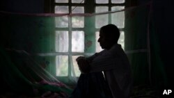 FILE - FILE- In this March 24, 2018 file photo, a tuberculosis patient sits on a bed at a TB hospital in Gauhati, India. 