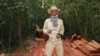 In this photo taken Feburary 6, 2012 and released by The Cambodian Center for Human Rights (CCHR), Chut Wutty stands on wooden planks of log in a jungle in Kampong Thom province in northern of Phnom Penh, Cambodia.