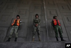 Soldiers stand guard to watch for passing migrants riding in public transportation in Tapachula, Chiapas state, Mexico, June 9, 2019.