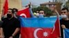 Demonstrators holding Azeri and Turkish flags shout slogans during a protest against Armenia near the Consulate of Azerbaijan in Istanbul, Turkey, Sept. 29, 2020.