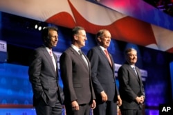 Republican presidential candidates, from left, Bobby Jindal, Rick Santorum, George Pataki, and Lindsey Graham take the stage during the CNBC Republican presidential debate at the University of Colorado, in Boulder, Colo., Oct. 28, 2015.