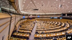 FILE - Members of the European Parliament attend a plenary session at the European Parliament in Brussels, Feb. 25, 2015. In a world of rising populism and fake news, the European Parliament is taking unusual steps to sweep clean hate speech in its own house.