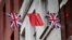 FILE - Chinese and British flags fly in London's Chinatown, Britain, Oct. 19, 2015. 