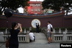 John Sugden and Kao Shaochun have their pre-wedding photos taken by Austin Haung, 32, as Lin Chinxuan, right, 29, stands by, in Taipei, Taiwan, Nov. 11, 2018.