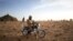 FILE - A soldier of the Burkina Faso Army sits on his motorcycle during a patrol in Burkina Faso, November 9, 2019. Two soldiers were killed by a homemade bomb in southeast Burkina Faso on October 11, 2021.
