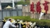 A man offers flowers outside the Zhuhai People's Fitness Plaza where a man rammed his car into people exercising at the sports center, in Zhuhai in southern China's Guangdong province on Nov. 13, 2024.