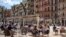 Customers sit and drink on a terrace bar in Tarragona, Spain, May 11, 2020. Roughly half of 47 million Spaniards are stepping into a softer version of the country's coronavirus strict confinement.